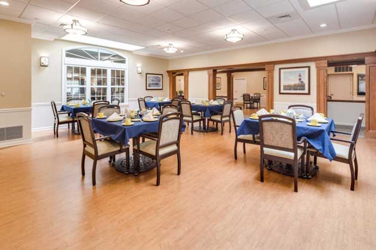 An elegantly set dining area with multiple tables and chairs.
