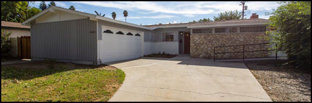 A suburban single-story house with a garage and driveway.