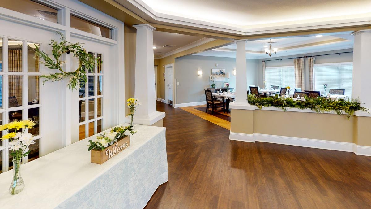 A well-lit lobby area featuring elegant decor and wood flooring.