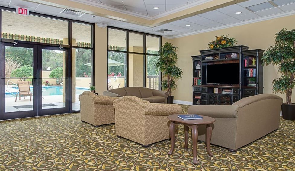 A cozy lobby area with sofas and a television.