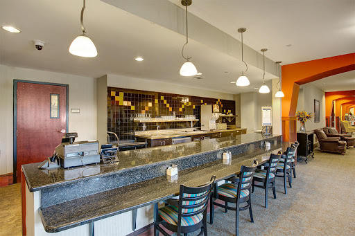 A modern restaurant bar featuring a sleek granite countertop and stylish seating.