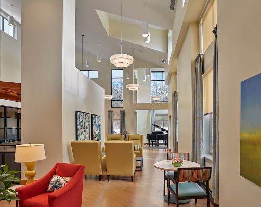 A modern lounge area featuring elegant furniture and ample natural light.