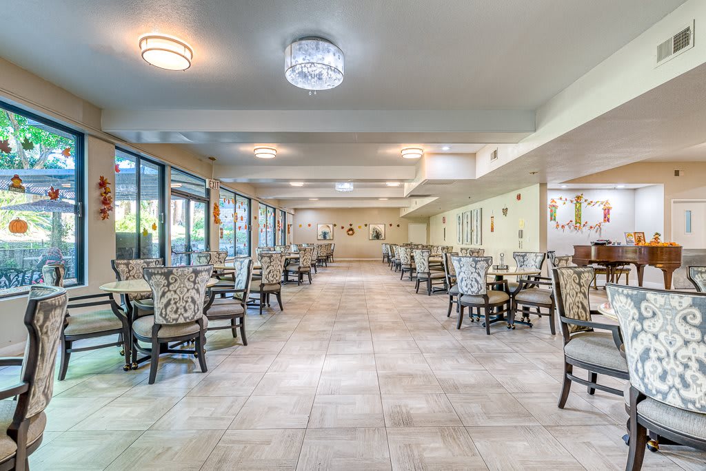 A spacious and elegantly designed dining area with neatly arranged tables and chairs.