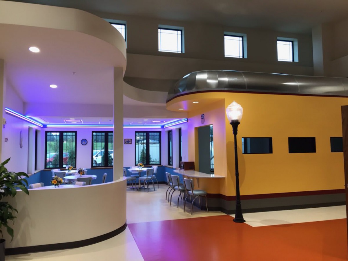 A retro 1950s-style diner interior with vintage decor and neon lighting.