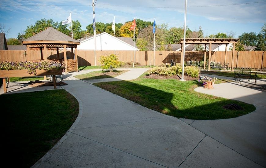 A beautifully landscaped outdoor area with a winding pathway and lush greenery.