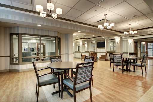 A modern dining area featuring stylish furniture and warm lighting.