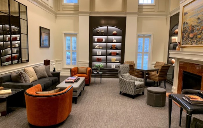 A cozy lounge area with comfortable seating and a modern bookshelf.