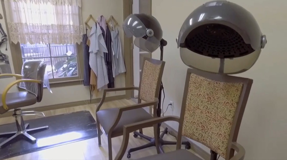 An interior view of a beauty salon featuring hair dryers and chairs.