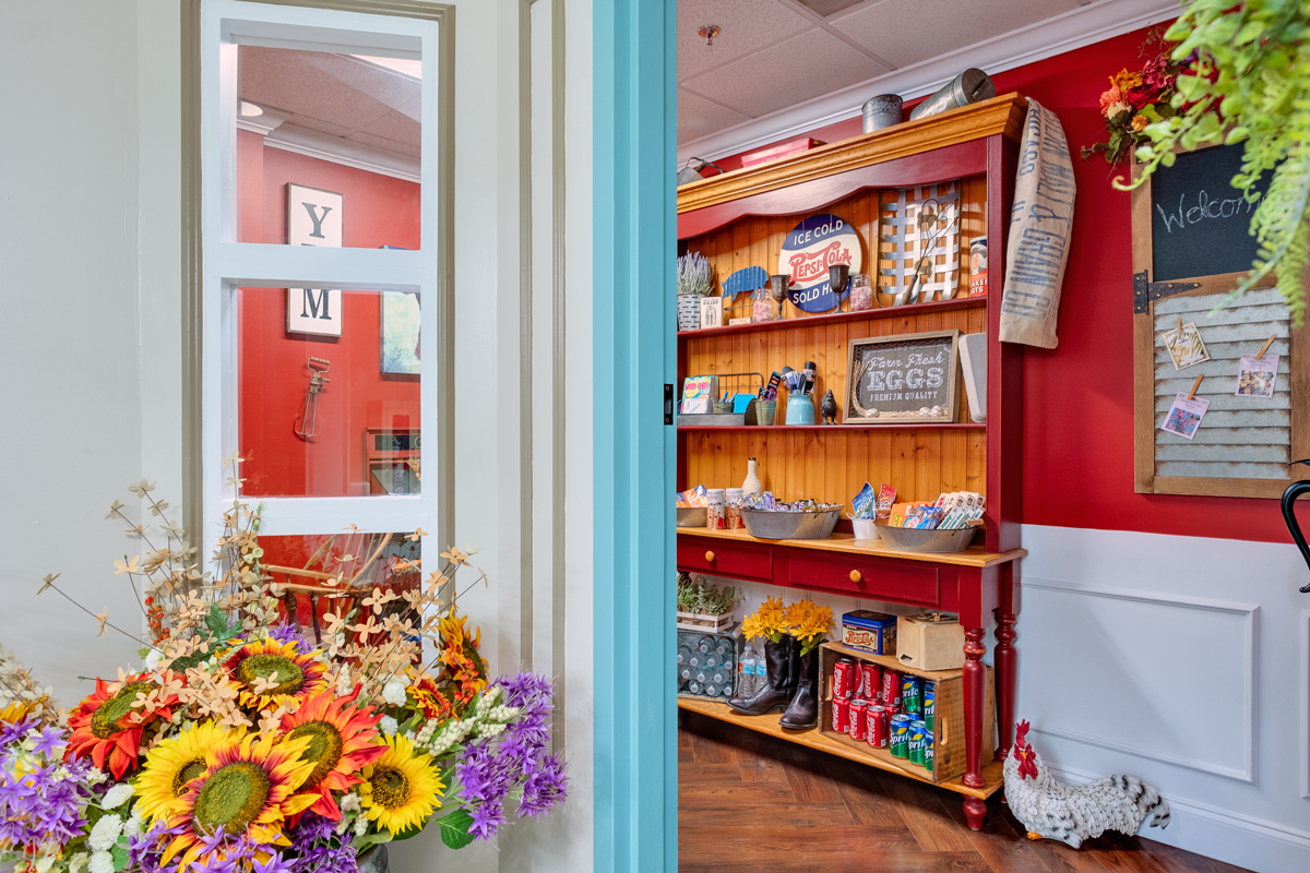 A vibrant indoor scene featuring a flower arrangement and shelves stocked with various items in a colorful grocery setting.