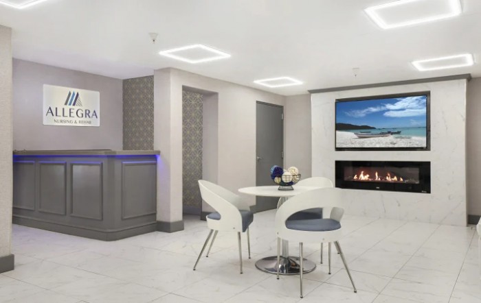 A modern lobby with contemporary furniture and a fireplace.