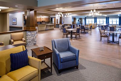 A spacious and well-lit lounge and dining area with comfortable seating and stylish decor.