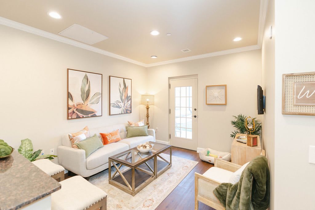 A modern and inviting living room with comfortable furniture, stylish artwork, and bright lighting.
