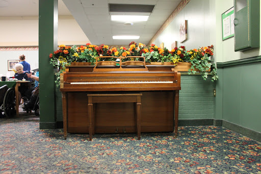 A beautifully decorated piano with floral arrangements in a cozy indoor space.