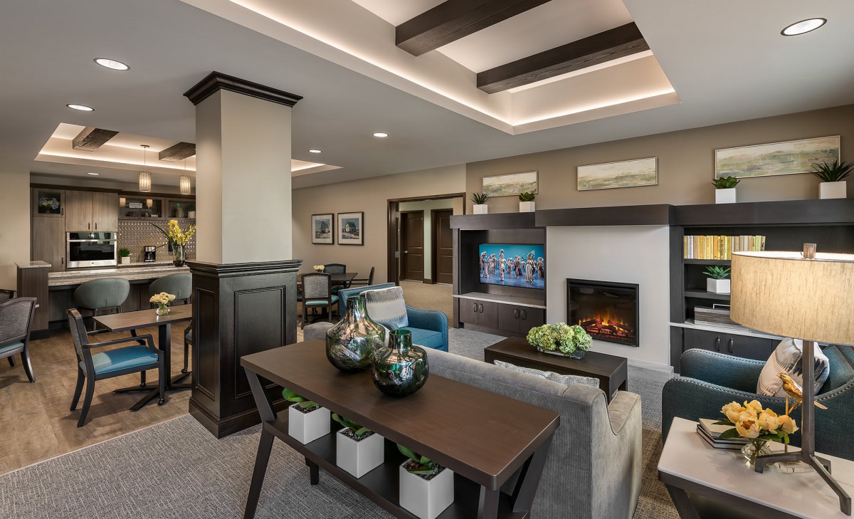 A modern living room featuring a cozy fireplace, stylish furniture, and elegant lighting.