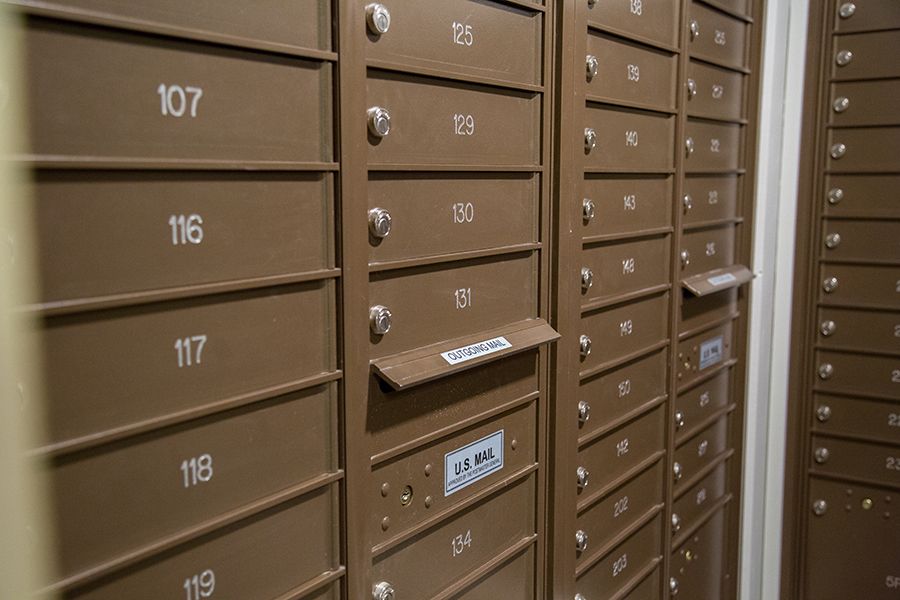 Rows of secure, numbered mailboxes in a postal facility.