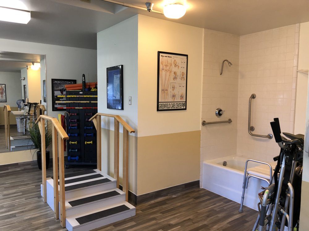 An accessible bathroom setup with safety rails and a step ramp for easy access.