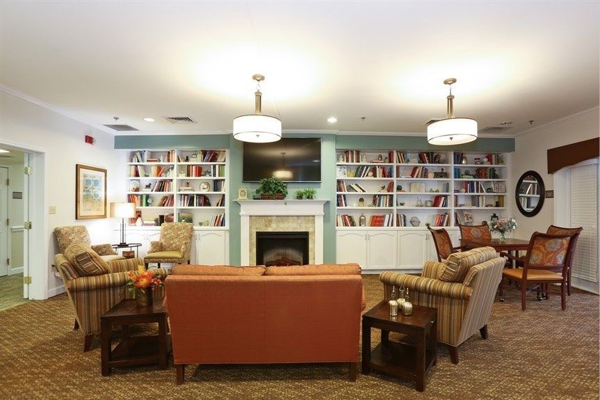 Cozy library interior with comfortable seating and a warm fireplace.