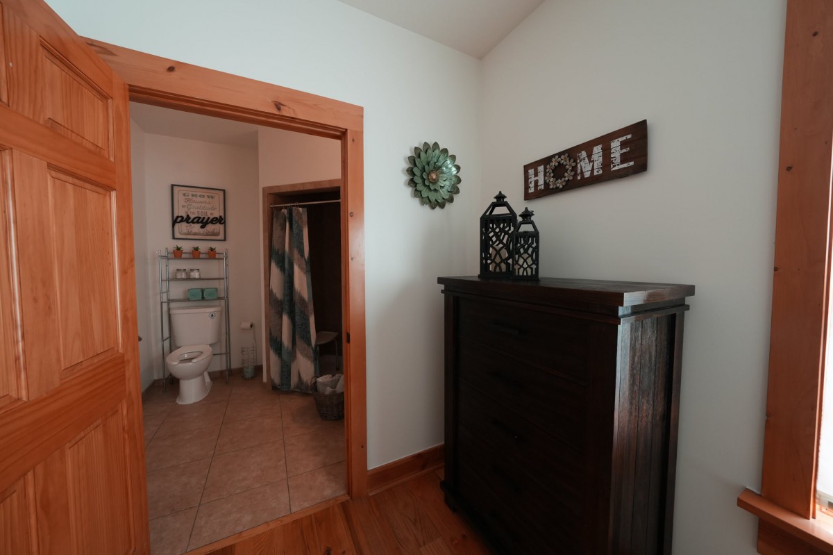 A cozy home interior with a view into the bathroom and decorative elements.
