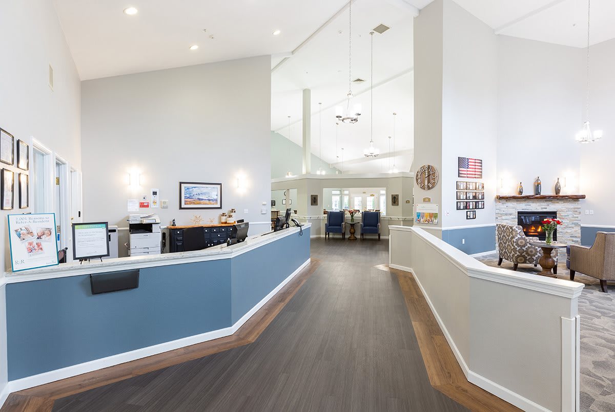 A modern reception area with bright lighting and a spacious hallway.