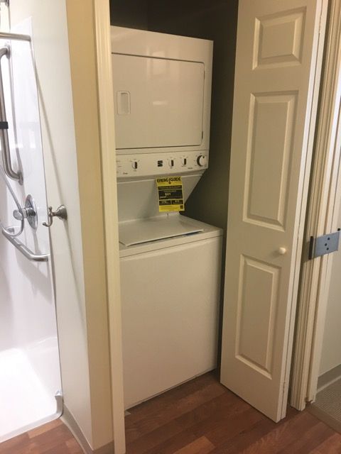 A compact laundry space with a stacked washer and dryer unit.