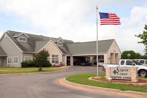 A welcoming entrance of a care facility with the American flag proudly displayed.