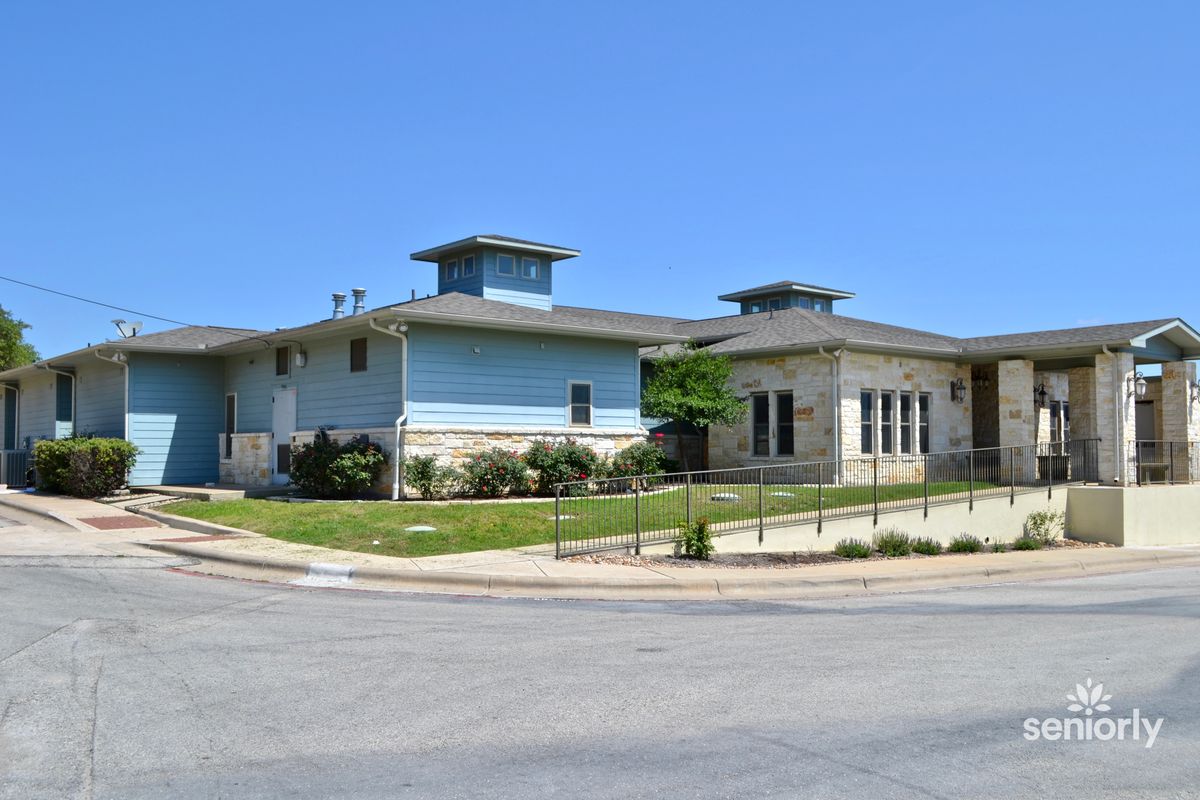 A modern residential building situated in a suburban area on a sunny day.