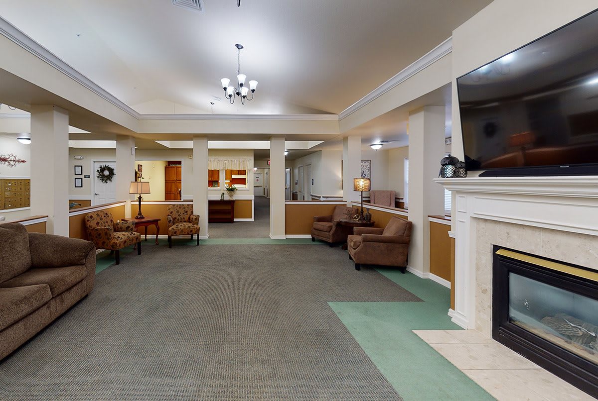 Spacious living area with comfortable seating and a fireplace.