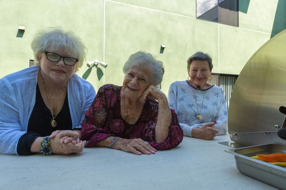A group of elderly women enjoying an outdoor gathering.