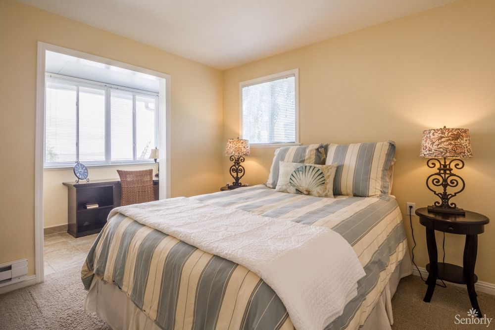 A cozy bedroom with striped bedding and a warm, inviting atmosphere.