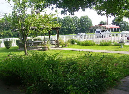 A serene park scene featuring lush greenery and a well-maintained pathway.