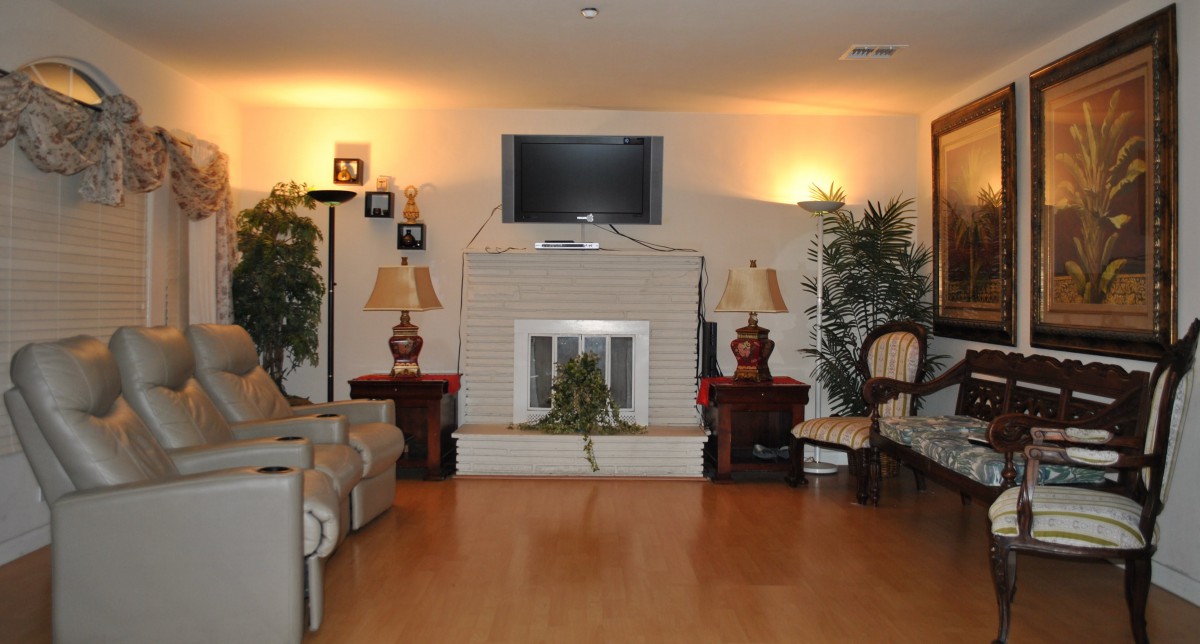 Cozy living room with a fireplace, television, and comfortable seating.