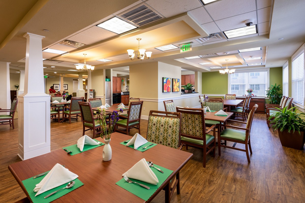 A well-lit restaurant dining area with neatly arranged tables and chairs.