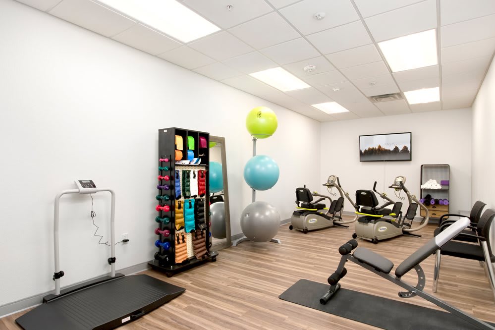 A modern fitness center equipped with a variety of exercise machines and equipment.