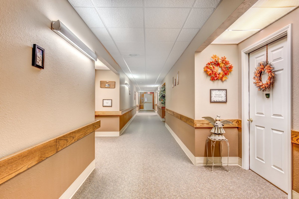 A clean and well-lit hospital corridor with artwork on the wall.