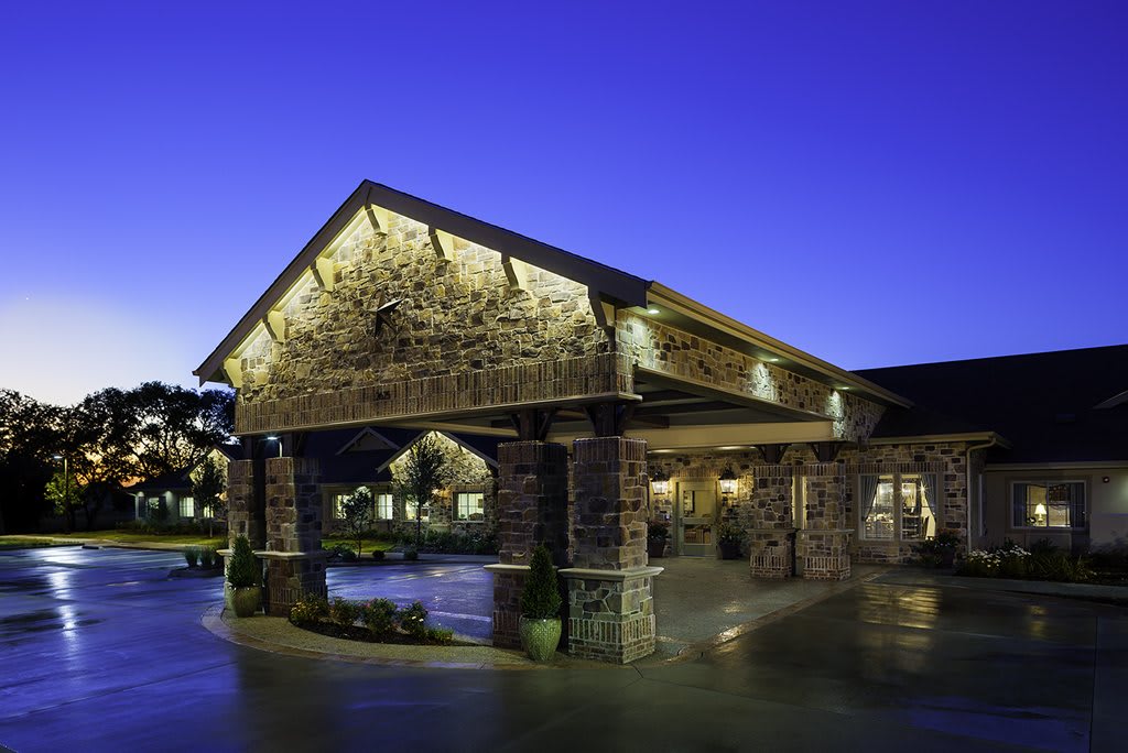 Stone building entrance illuminated at night.