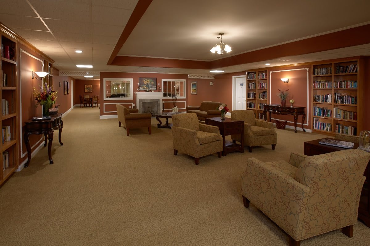 A spacious living room with comfortable seating, a fireplace, and warm lighting.