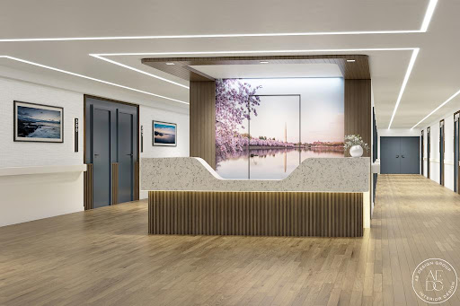 A sleek and modern reception area featuring elegant wood accents and a scenic artwork backdrop.