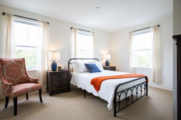 A cozy bedroom with a modern design featuring a metal-framed bed and stylish decor.