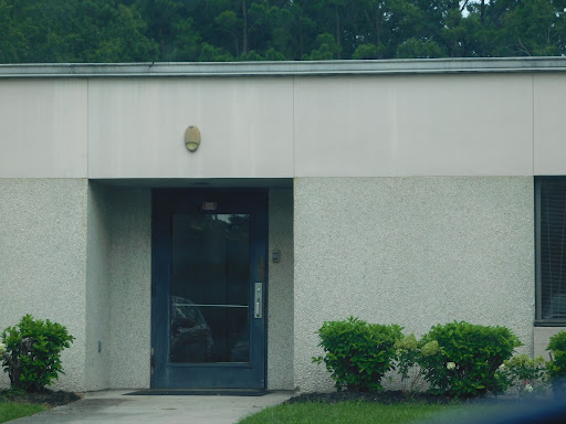 A simple building entrance surrounded by greenery.