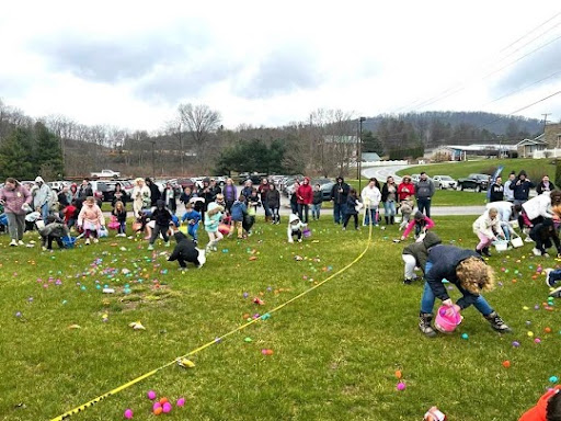 Children and families enjoy a lively Easter egg hunt in a community park.