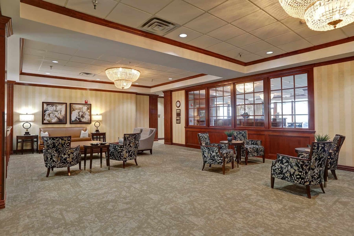 A spacious and elegantly decorated lobby with comfortable seating and chandeliers.
