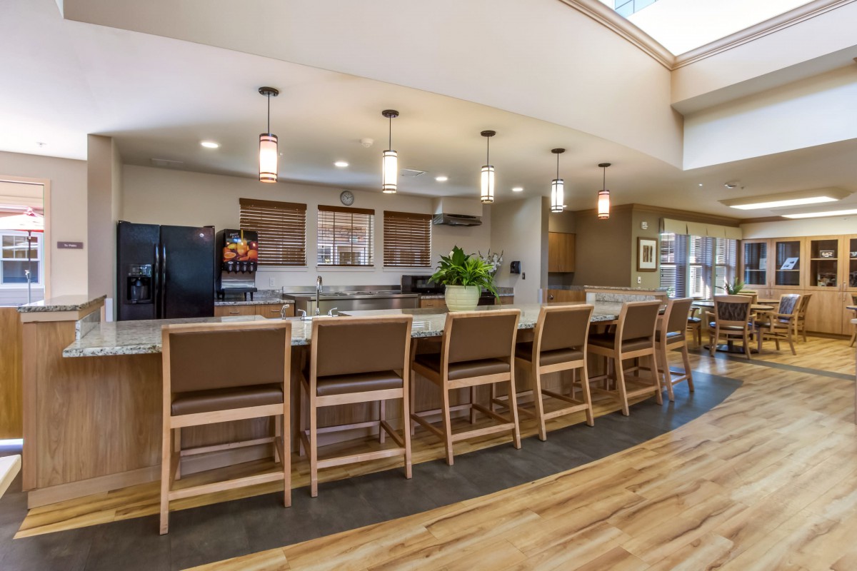 Modern kitchen interior with a long counter and seating.