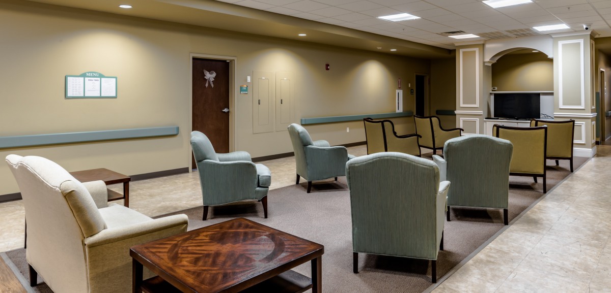A waiting room with several chairs arranged in a comfortable seating area.