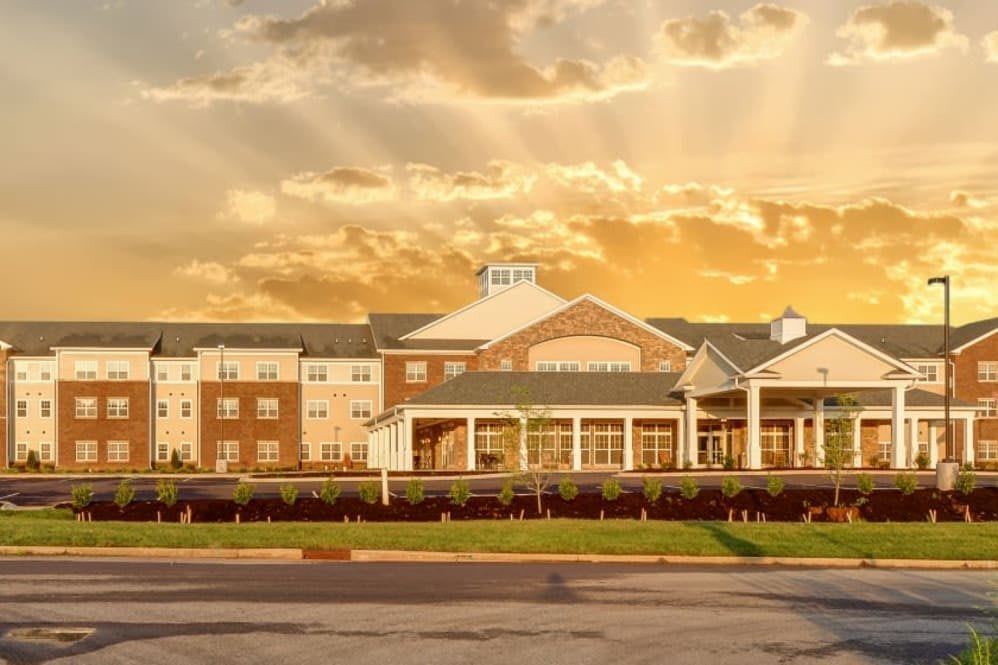 A hotel building under a dramatic sunset sky.