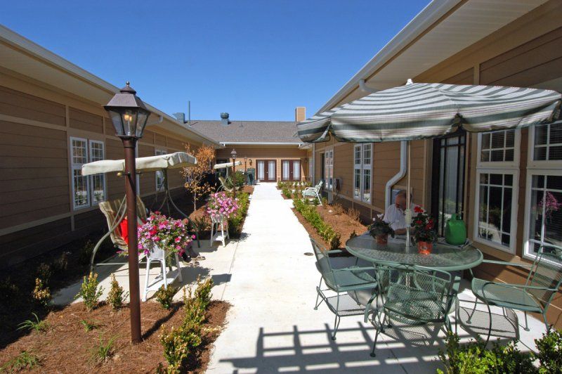 A sunny courtyard with outdoor seating and landscaping.