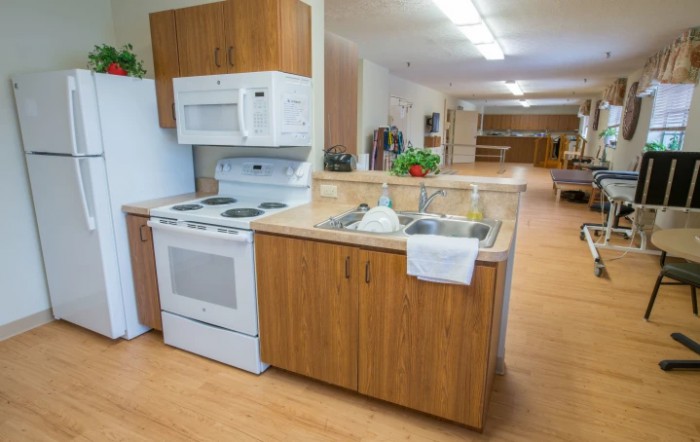 A modern kitchen with wooden cabinets, a stove, and a microwave.