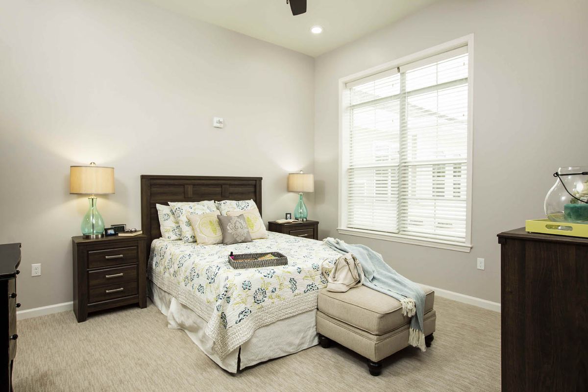 A cozy bedroom with elegant decor and ample natural light.