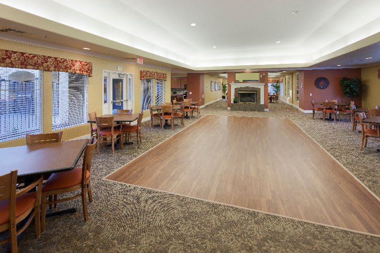 Spacious dining area with tables, chairs, and a fireplace.