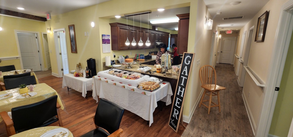 A cozy home gathering with a buffet-style food setup in the kitchen.