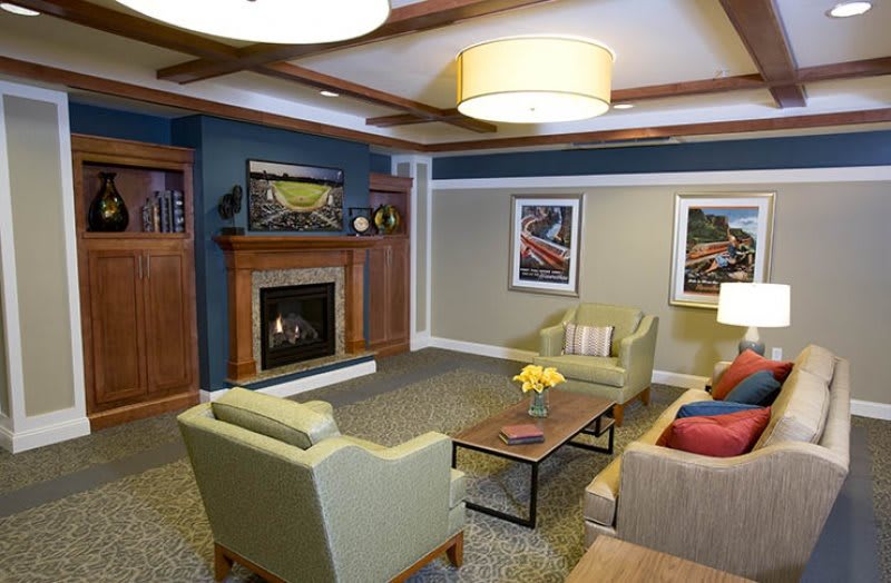 A cozy living room with comfortable seating, a fireplace, and modern decor.
